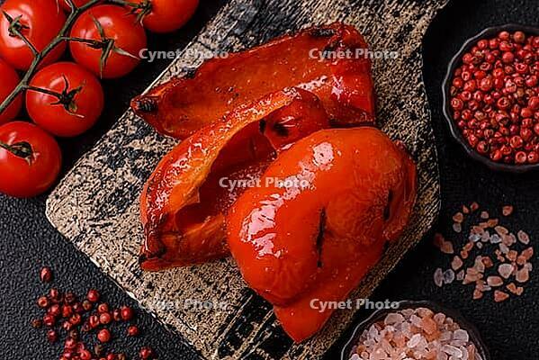 Grilled red bell peppers, vegetarian food. Red bell peppers as a food background for your design [IBR124865287]