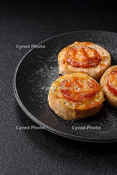 Round fish or chicken cutlets baked with tomato and cheese. Fish cutlets as a food backdrop for your design [IBR124865302]