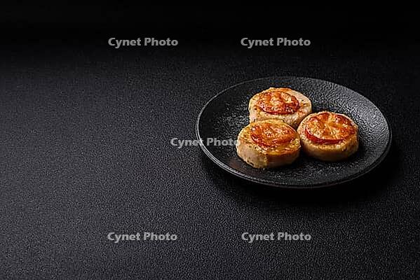 Round fish or chicken cutlets baked with tomato and cheese. Fish cutlets as a food backdrop for your design [IBR124865303]