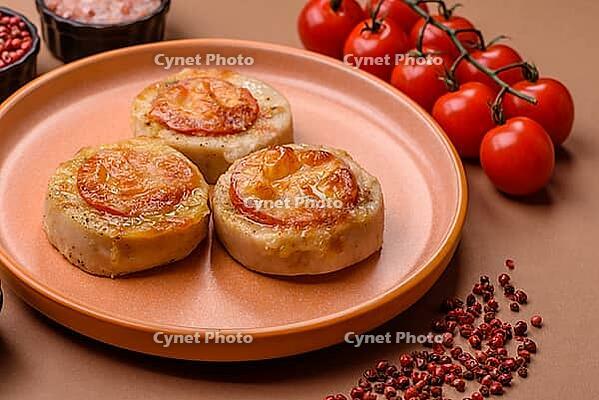 Round fish or chicken cutlets baked with tomato and cheese. Fish cutlets as a food backdrop for your design [IBR124865307]