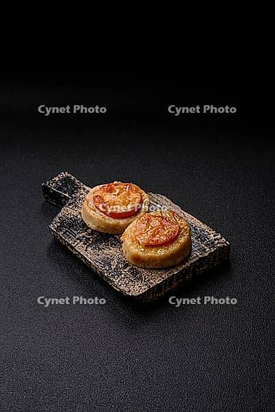 Round fish or chicken cutlets baked with tomato and cheese. Fish cutlets as a food backdrop for your design [IBR124865309]