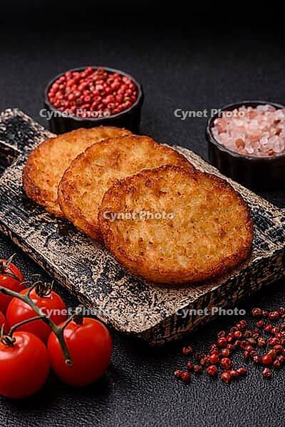 Potato hash browns, a cooked vegetable breakfast food. Potato hash browns as a food background for your design [IBR124865312]