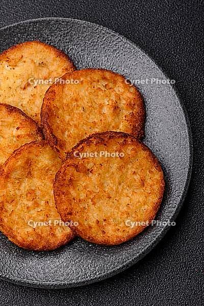Potato hash browns, a cooked vegetable breakfast food. Potato hash browns as a food background for your design [IBR124865314]