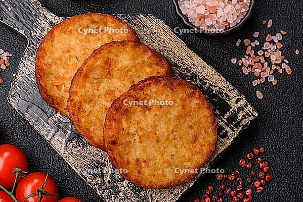 Potato hash browns, a cooked vegetable breakfast food. Potato hash browns as a food background for your design [IBR124865316]