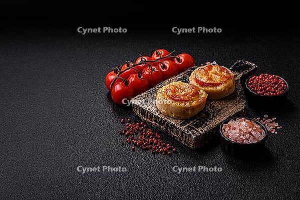 Round fish or chicken cutlets baked with tomato and cheese. Fish cutlets as a food backdrop for your design [IBR124865319]