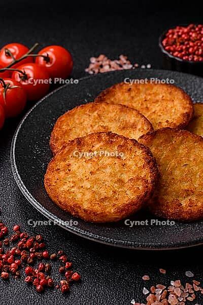 Potato hash browns, a cooked vegetable breakfast food. Potato hash browns as a food background for your design [IBR124865321]
