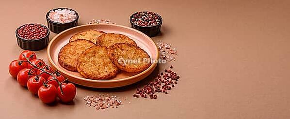Potato hash browns, a cooked vegetable breakfast food. Potato hash browns as a food background for your design [IBR124865323]