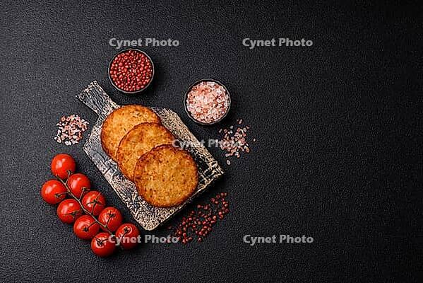 Potato hash browns, a cooked vegetable breakfast food. Potato hash browns as a food background for your design [IBR124865324]