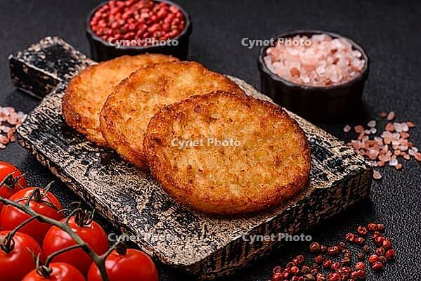Potato hash browns, a cooked vegetable breakfast food. Potato hash browns as a food background for your design [IBR124865325]