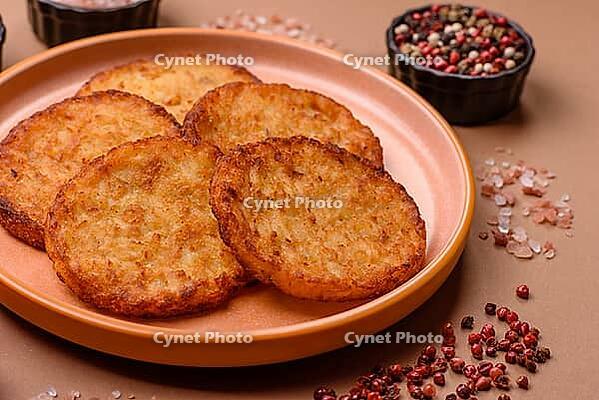 Potato hash browns, a cooked vegetable breakfast food. Potato hash browns as a food background for your design [IBR124865326]