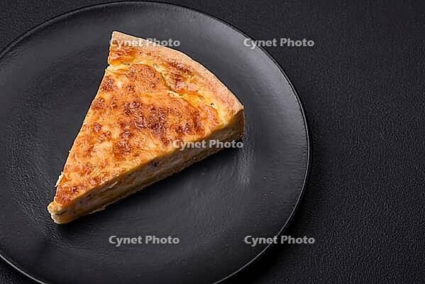 Food, Beautiful delicious quiche pie with four types of cheese with spices and herbs on a dark concrete background [IBR124876431]