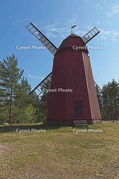 Ancient red wooden windmill with rotor in summer, Loviisa, Finland [IBR124899515]