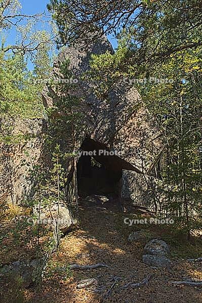 Rock formation of Korsvikin stone church forming a cave in forest in summer, Pernaja, Finland [IBR124899518]