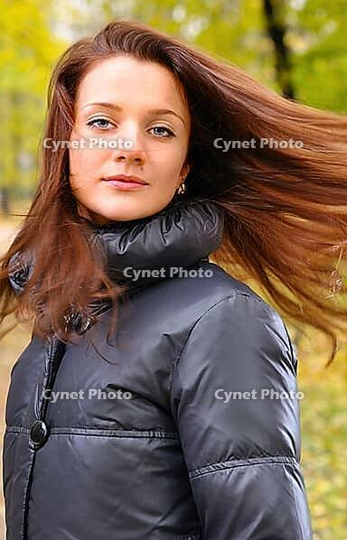 Pretty woman is shaking her hair and looking at camera [IBR124906341]