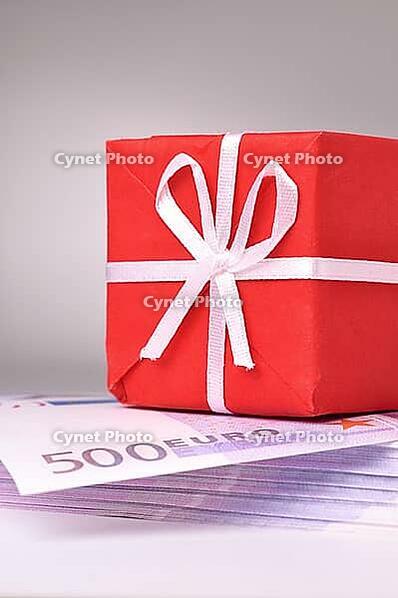Red gift box on the batch of euro notes [IBR124906343]
