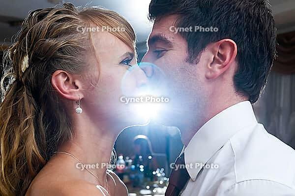Just married couple is kissing at wedding celebration party [IBR124906375]