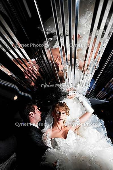 Bride and groom at limo with mirror ceiling [IBR124906381]