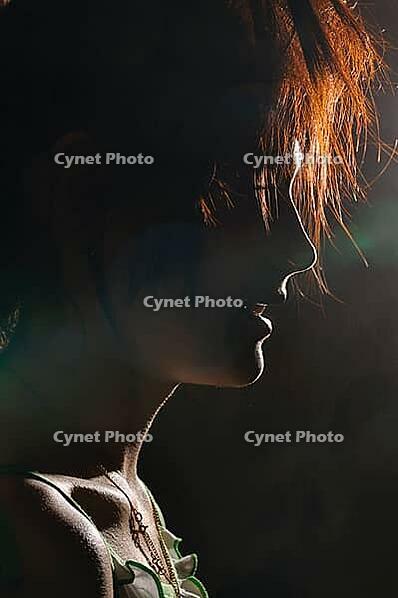 Silhouette at night of a young ginger woman [IBR124906385]