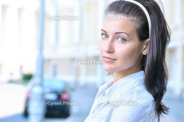 Closeup portrait of a woman at sunny street [IBR124906397]