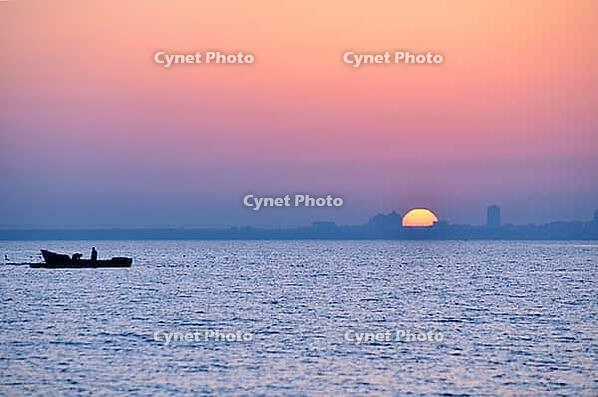 City silhouette from sea at sunrise [IBR124906417]