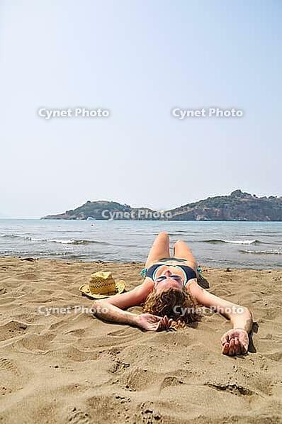 Sexy woman is lying on the beach [IBR124906432]