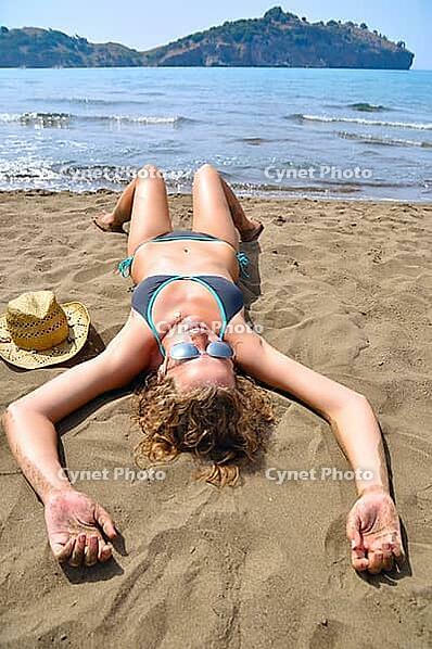 Sexy woman is lying on the beach and, top view [IBR124906435]