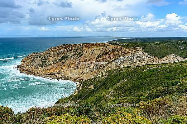 View of a rocky coast by the sea under a slightly cloudy sky, near Setubal in spring 2019 [IBR124915264]