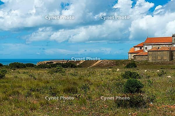View of an old building on the Atlantic coast under a slightly cloudy sky, near Setubal in spring 2019 [IBR124915267]