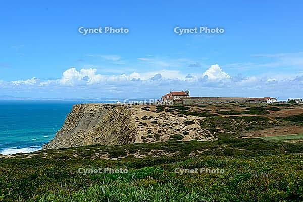 View of a rocky coast by the sea under a slightly cloudy sky, near Setubal in spring 2019 [IBR124915270]