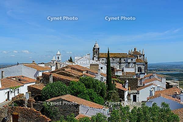 View from above over the rooftops of the city against a slightly cloudy sky, Monsaraz in spring 2019 [IBR124915285]