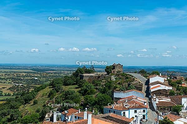 View from above over the rooftops of the city against a slightly cloudy sky, Monsaraz in spring 2019 [IBR124915287]