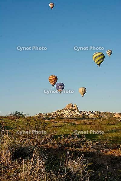 Scenic morning view of colorful hot air balloons soaring over the unique Cappadocia landscape, Turkey [IBR124920190]