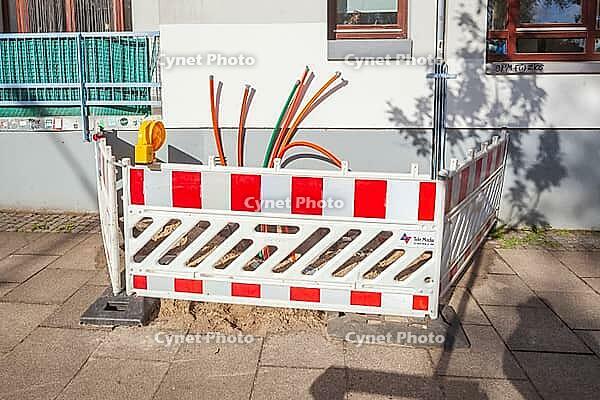 Construction site for laying fiber optic cables in front of a residential building, Bremen, Germany [IBR124920246]