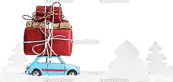 Blue retro toy car delivering Christmas or New Year gifts, isolated on white [IBR124944037]