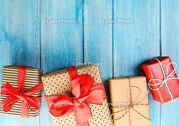 Christmas or New Year decorated gift boxes on blue wooden background [IBR124944039]