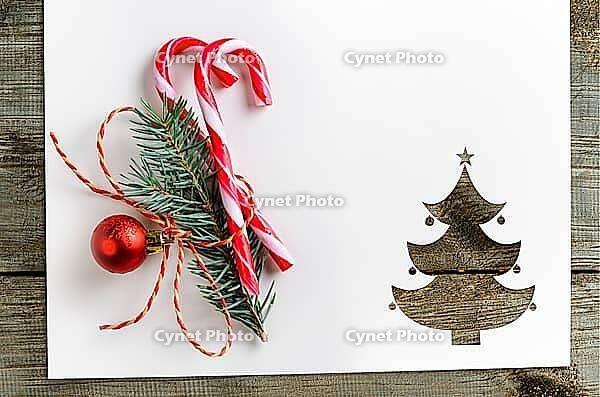 Cut paper in fir-tree shape with decoration for christmas card or new year background on wooden table [IBR124944043]