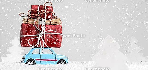 Blue retro toy car delivering Christmas or New Year gifts on gray background [IBR124944044]