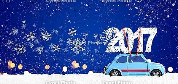 Blue retro toy car delivering Christmas or New Year 2017 on festive blue background [IBR124944048]