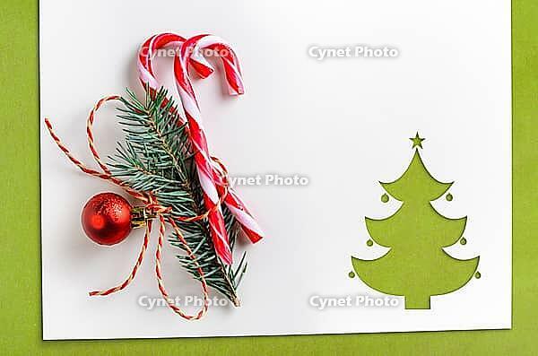 Cut paper in christmas tree shape with decoration for christmas card or new year background on green table [IBR124944056]