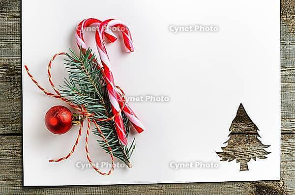 Cut paper in christmas tree shape with decoration for christmas card or new year background on wooden table [IBR124944058]