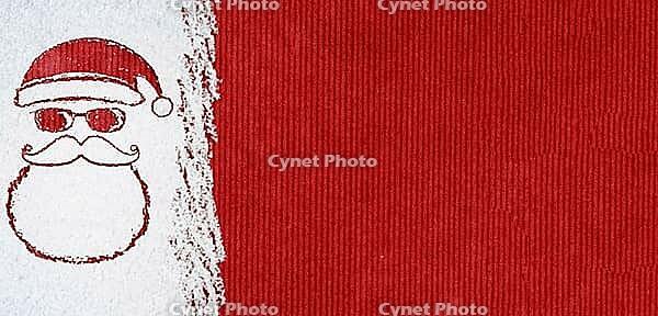 Christmas card or new year background made of santa claus symbol handwritten on snow and red craft paper [IBR124944061]