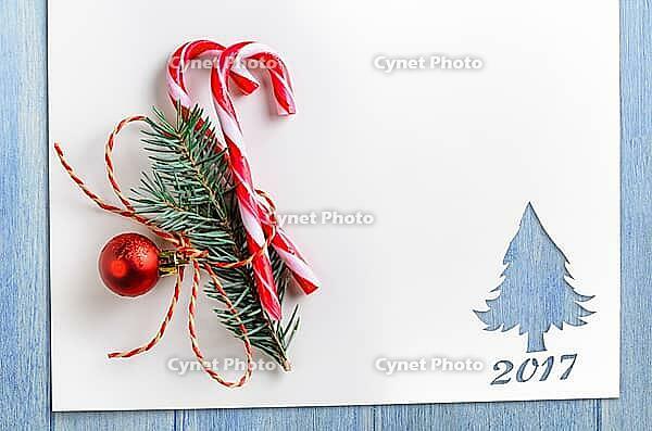 Cut paper in fir-tree shape with decoration for christmas card or new year background on blue table [IBR124944064]