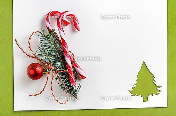 Cut paper in fir-tree shape with decoration for christmas card or new year background on green table [IBR124944065]