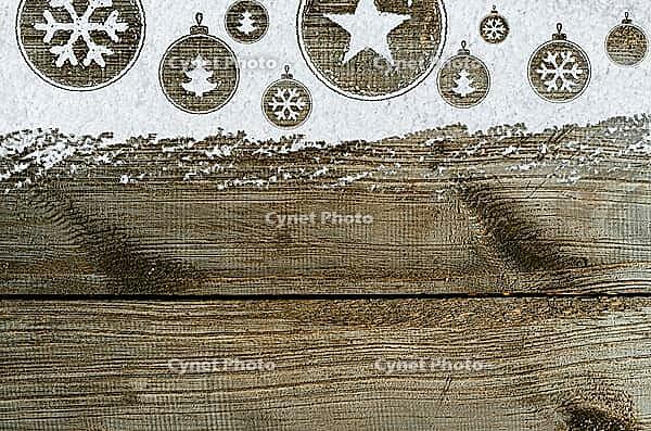 Christmas card or new year background made of xmas symbols handwritten on snow and wooden table [IBR124944066]