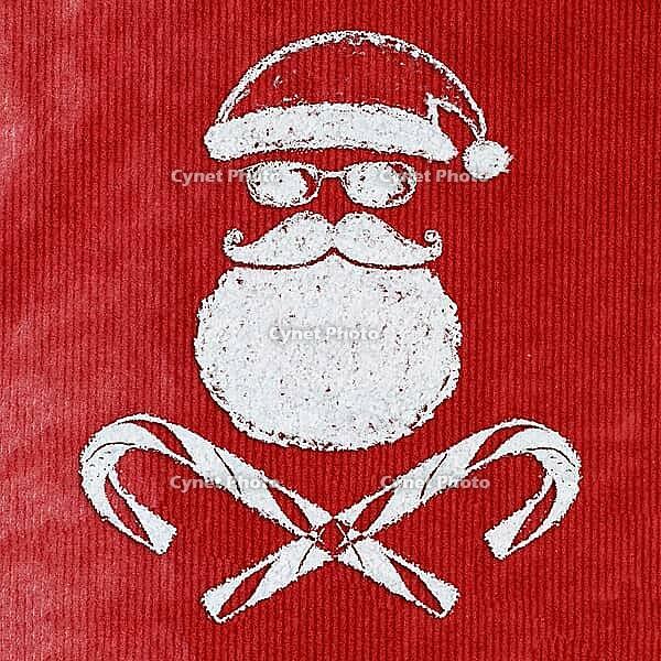 Bad Santa Claus symbol handwritten on christmas or new year card made of snow background with red craft paper below [IBR124944071]