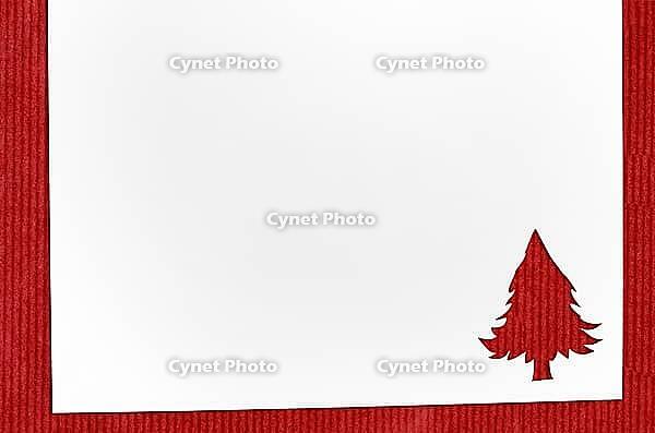 Cut paper in christmas tree shape for christmas card or new year background on red table [IBR124944076]