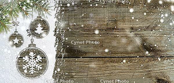 Christmas card or new year background made of xmas symbols handwritten on snow with fir-tree branches and wooden table [IBR124944089]