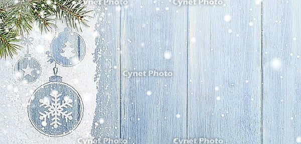Christmas card or new year background made of xmas symbols handwritten on snow with fir-tree branches and blue wooden table [IBR124944094]