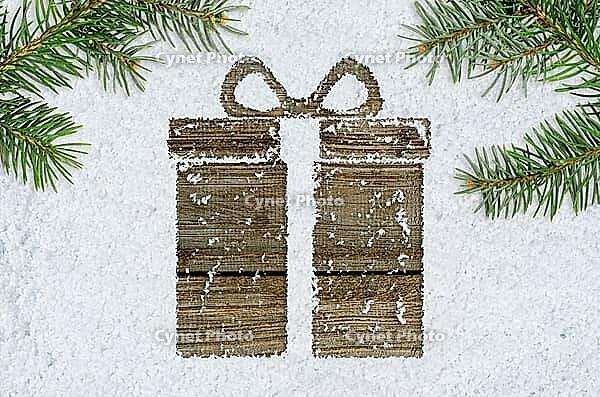 Christmas card or new year background made of gift box handwritten on snow and fir-tree branches over wooden table [IBR124944096]