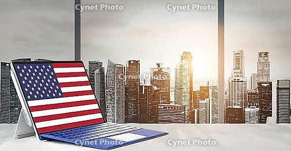 Independence Day on office laptop screen with panoramic sunset view of modern downtown skyscrapers at business district [IBR124944104]